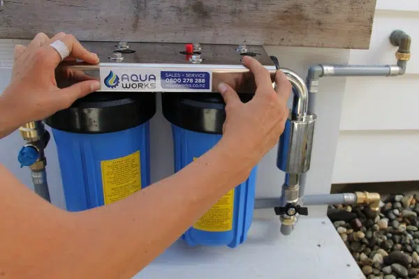 Whole house water filtration system being installed for silica and water spotting removal