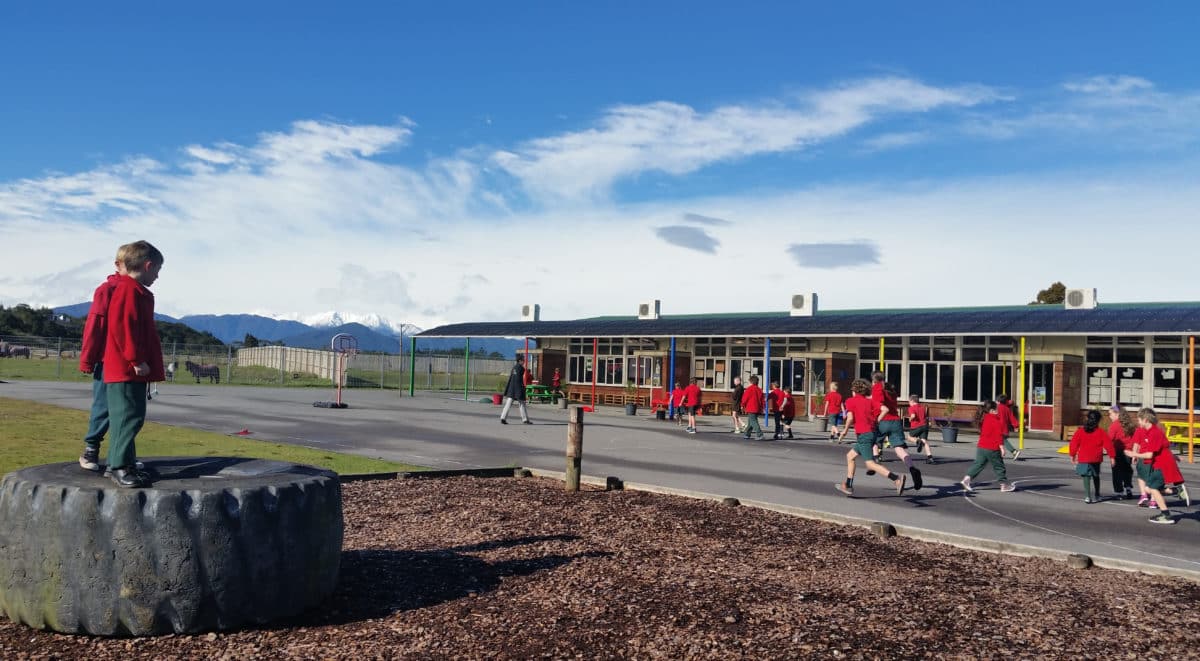 Children playing outside a rural New Zealand school