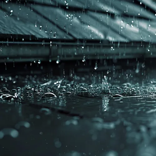 Rain running off a roof into a rainwater tank
