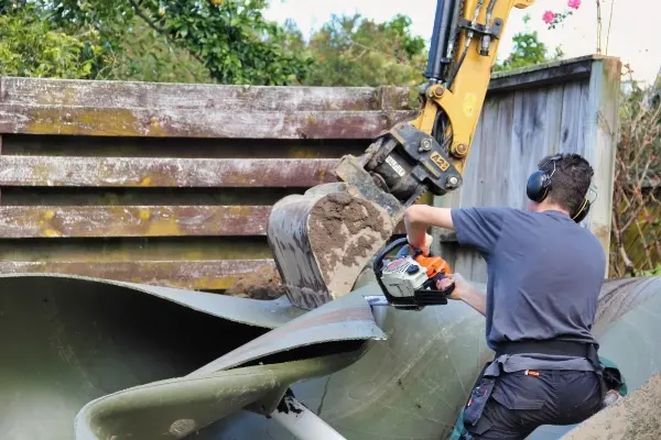 Aqua Works removing a damaged water tank in sections at a Snells Beach property<br />
