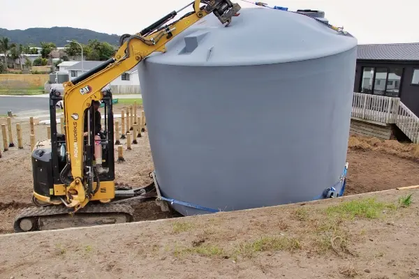 30,000-litre rainwater tank being moved into position during a new build in Mangawhai