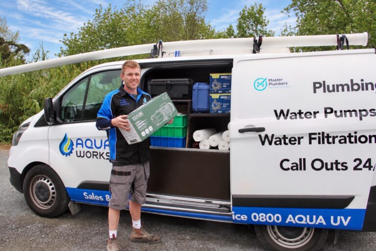 Zane, Aqua Works plumber, grabbing a new water pump from his service van