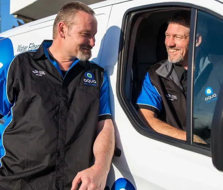 Aqua Works mobile service technicians sharing a laugh at the service van