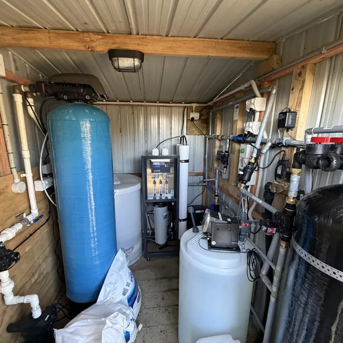 Large Autotrol water softener next to a commercial reverse osmosis system in a plant shed