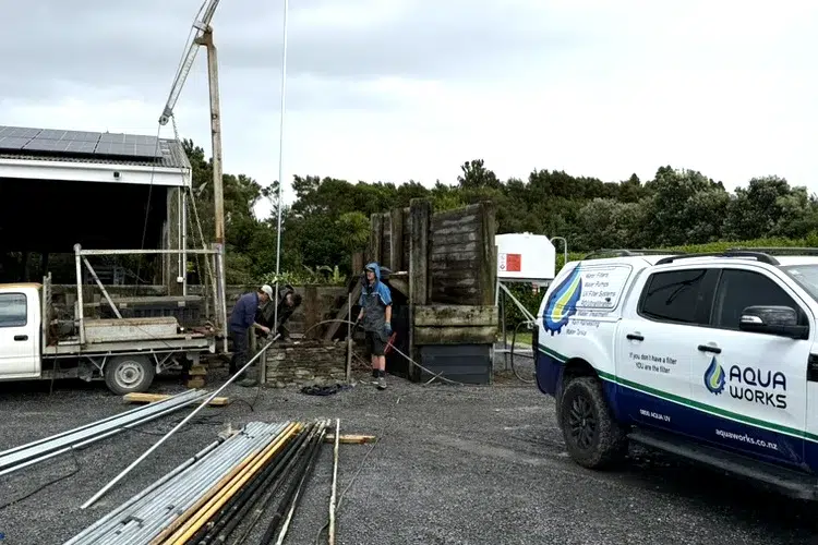 Aqua Works team pulling a bore pump on a rural property, with the Aqua Works ute