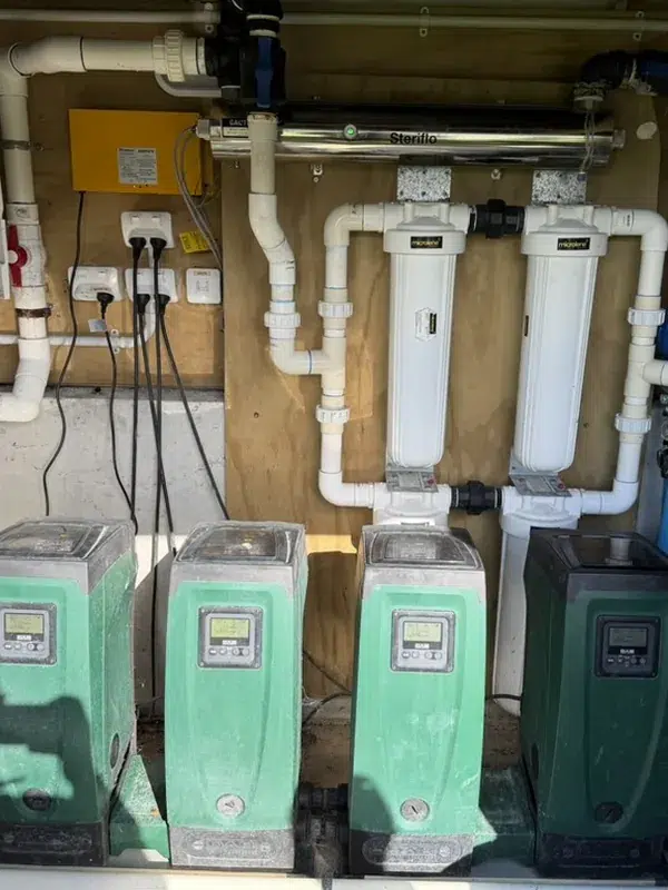 Four pressure pumps, cartridge filters and a UV system in a commercial treatment shed