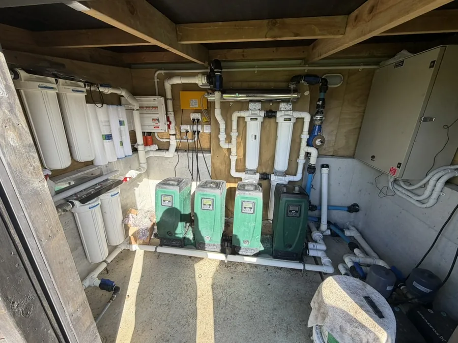 Commercial water treatment shed with cartridge filters, reverse osmosis and four pressure pumps