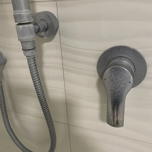 Shower mixer crusted with white scale