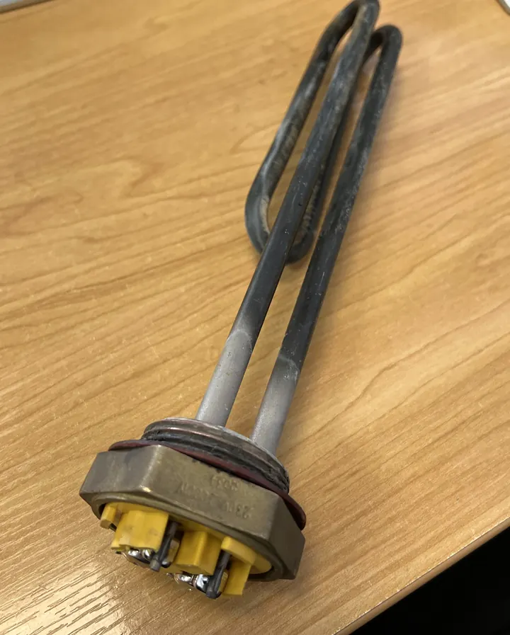Hot water cylinder element furred up with scale from hard bore water