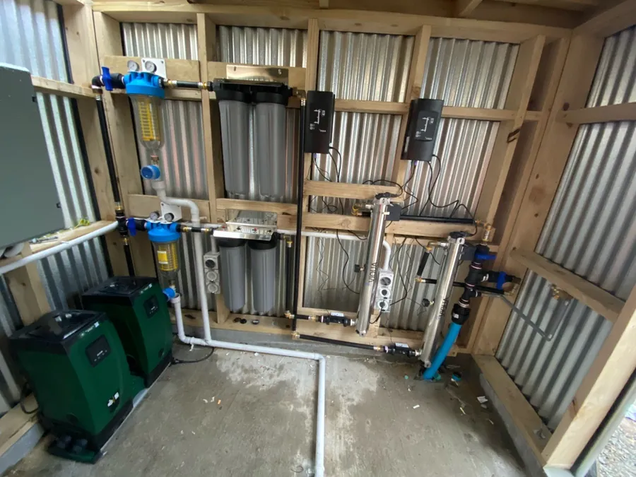 New commercial water treatment plant with twin pumps, self-cleaning filters and two UV systems in a timber plant shed