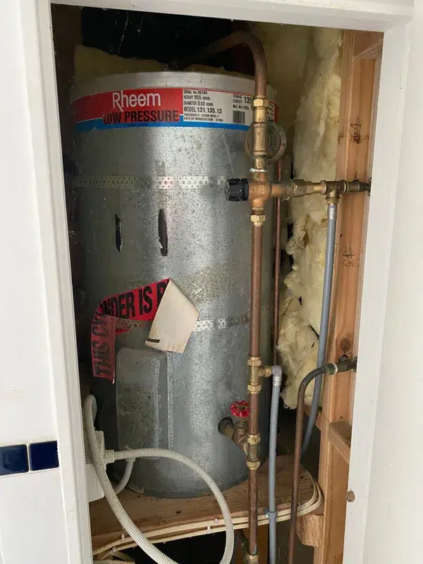 Old 1996 low pressure hot water cylinder in a cupboard, due for replacement