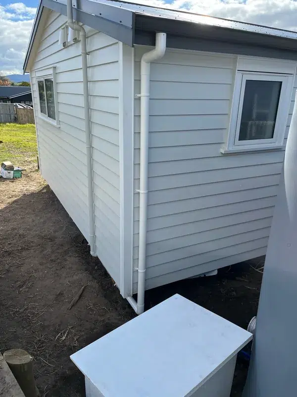 Closed pump box beside a new weatherboard home