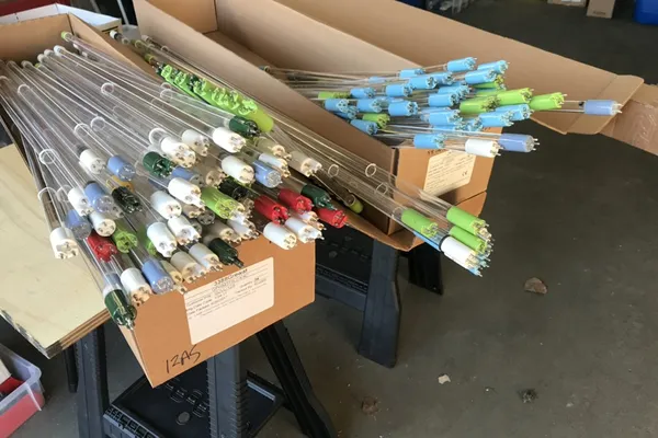 Boxes of UV lamps from many brands, changed by Aqua Works during UV services