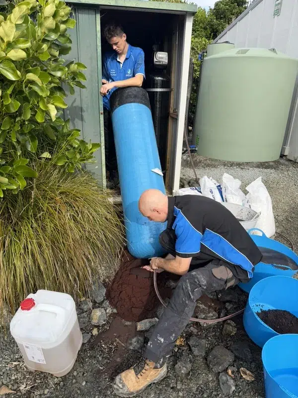 Aqua Works technicians replacing the resin in a commercial water softener