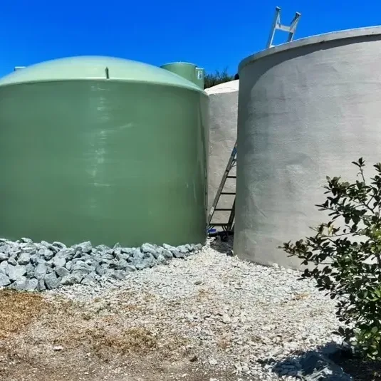 Green and grey rainwater tanks at a Warkworth home
