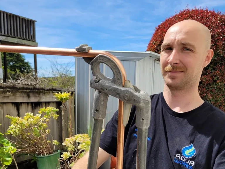 Troy, Aqua Works plumber, bending copper pipe for a hot water cylinder installation