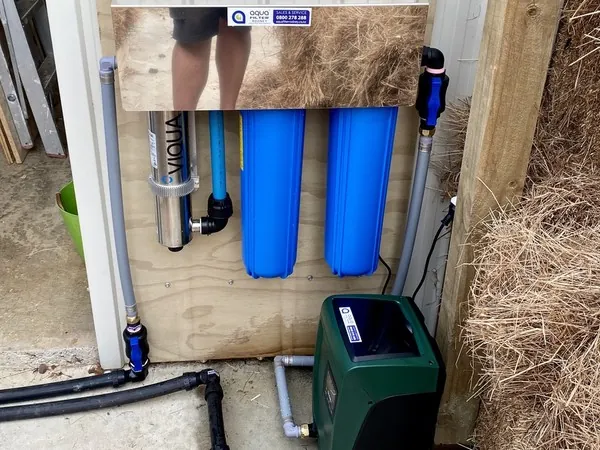 Viqua UV system and twin blue filters under a stainless cover, with a DAB pump below, in a shed at Kaipara Flats