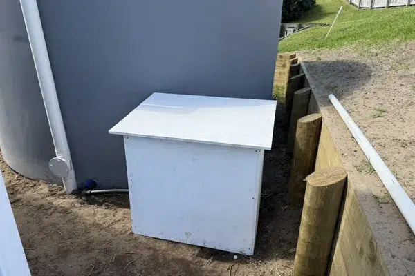 New water tank with its downpipe, and the cover box for the UV system and pump, at a new home on Marram Place, Mangawhai Heads