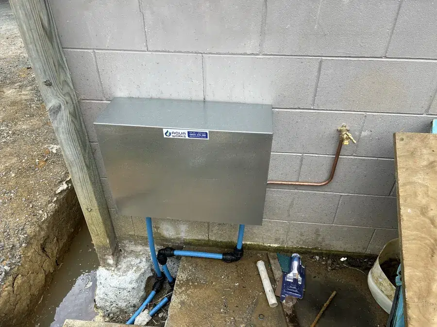 Galvanised cover fitted over a whole house ioniser system at a Warkworth home
