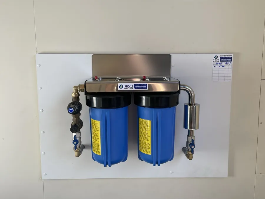 Whole house ioniser in an Orewa garage: sediment filter, carbon and KDF filter, and the stainless ioniser on the outlet